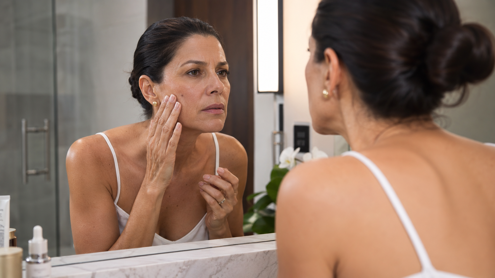 Woman in her 40s looking at her adult acne Woman in her 40s looking at her adult acne