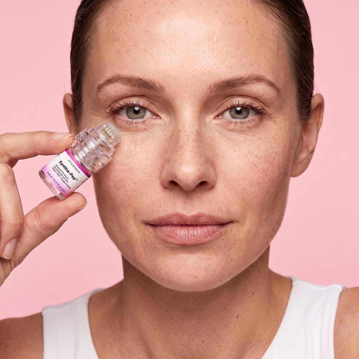 Woman using the MicroInfuser applicator beside her eye, front view Woman using the MicroInfuser applicator beside her eye, front view