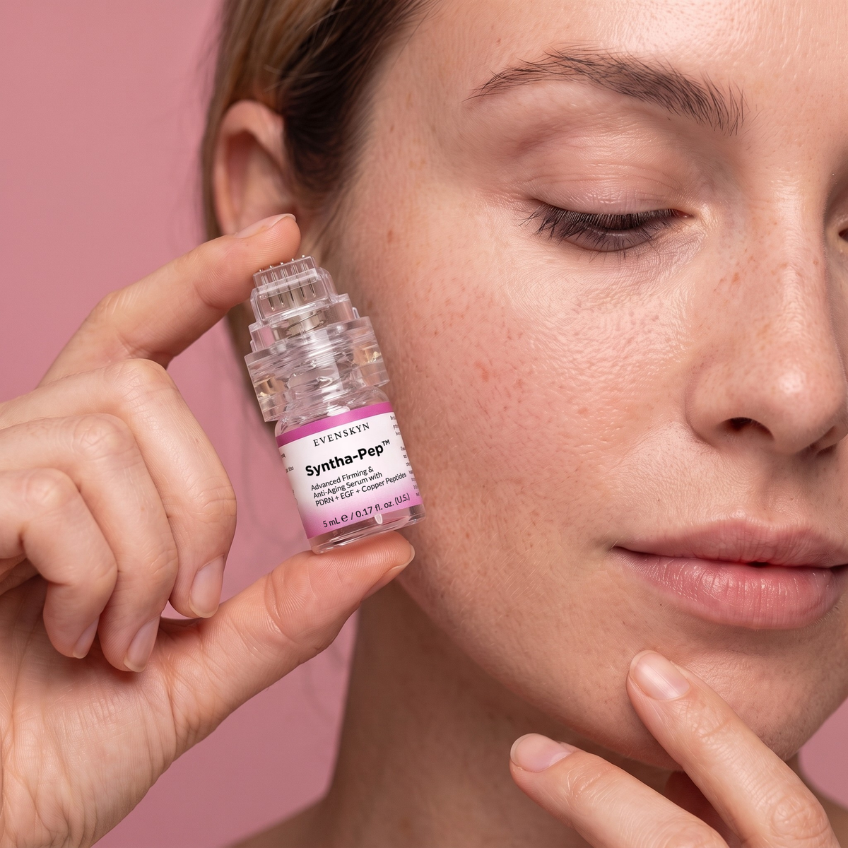 Close-up of a woman pressing the MicroInfuser applicator to her cheek Close-up of a woman pressing the MicroInfuser applicator to her cheek