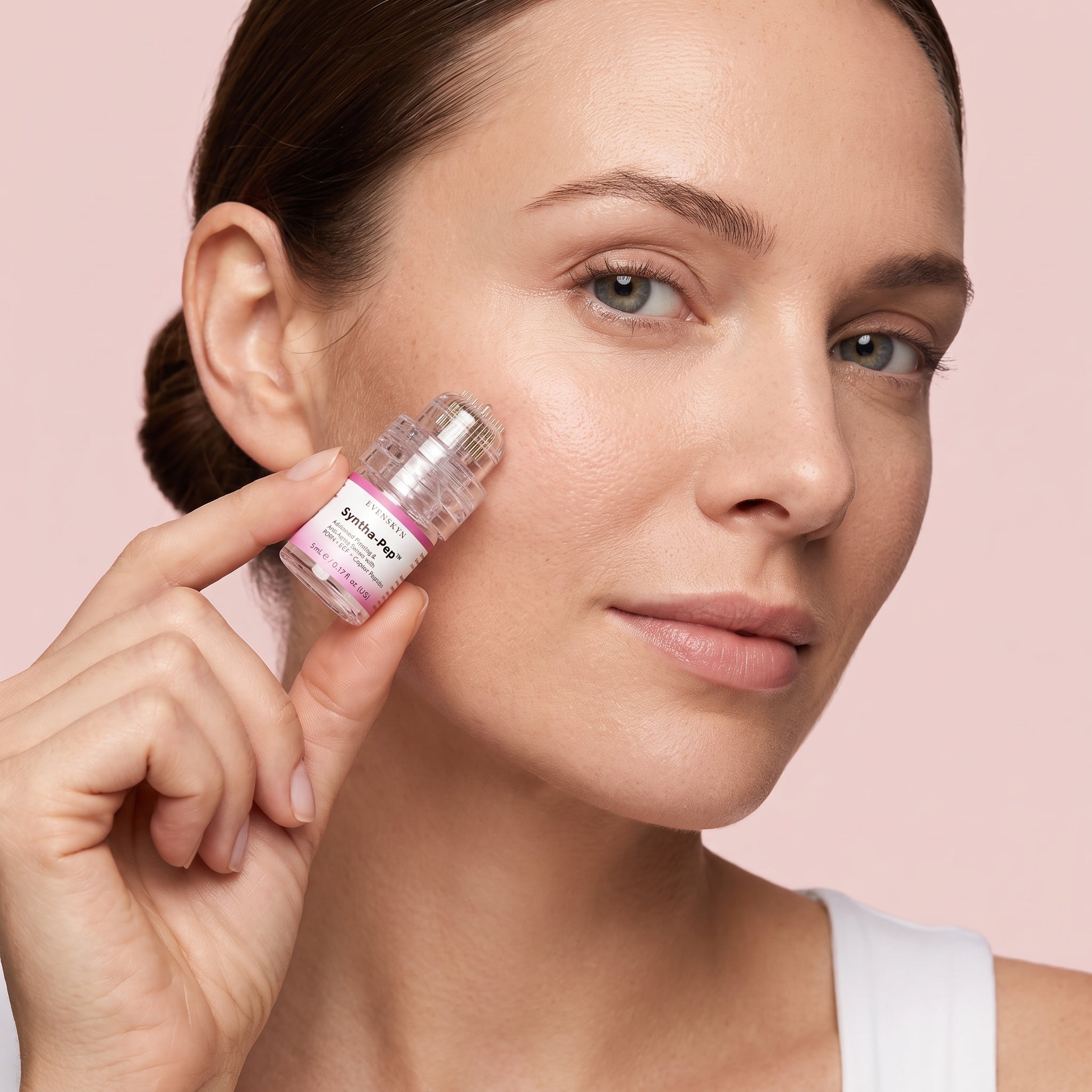 Applicator head flat on the cheek at 90 degrees, tap and lift