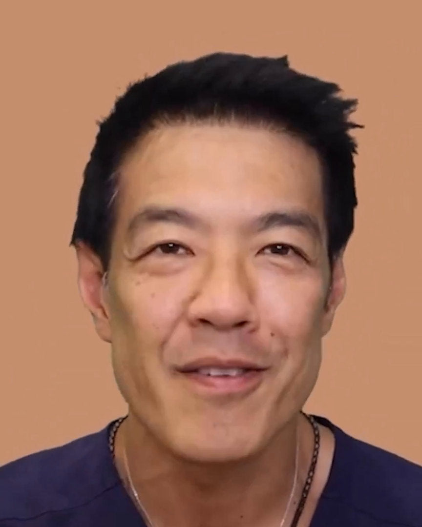 Dr. Davin Lim holding the original EvenSkyn Lumo